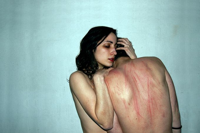 Woman hugging man with red striped back Woman hugging man with red striped back