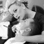 Woman shaving man with straight razor